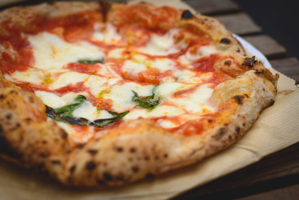 Close up view of a Margherita Neapolitan style pizza with buffalo mozzarella tomato sauce and basil Landscape format